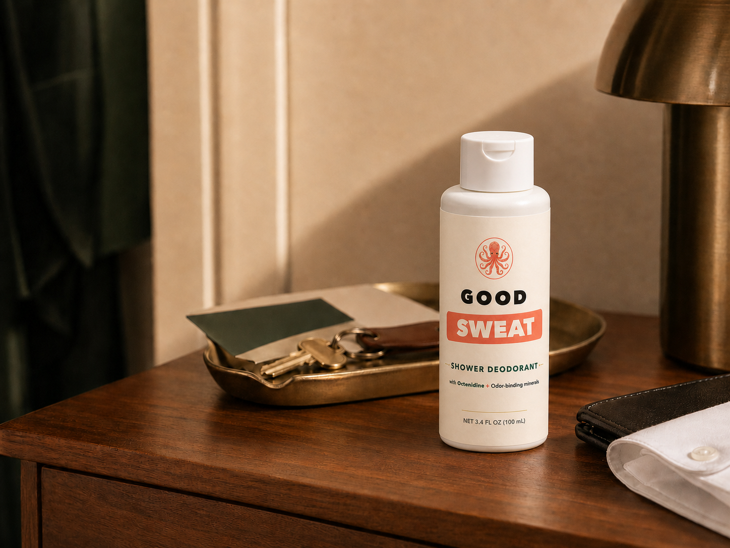GoodSweat shower deodorant bottle arranged with editorial source desk materials.