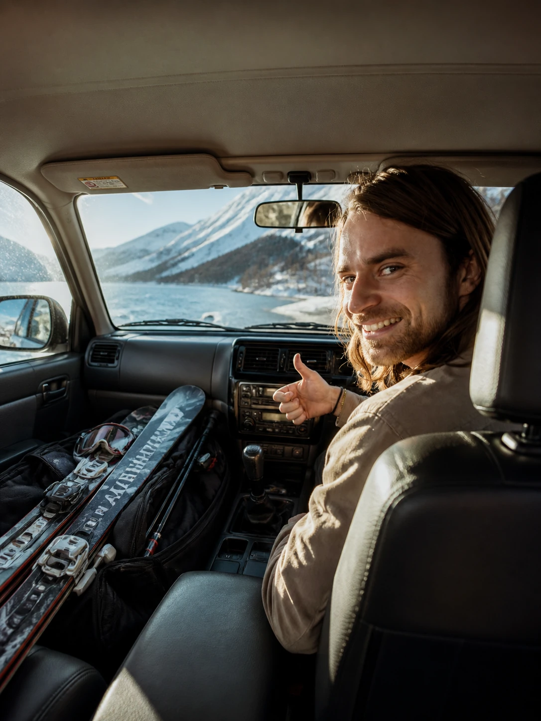 Hank smiling in a car with skis and snowy Hokkaido mountains outside.